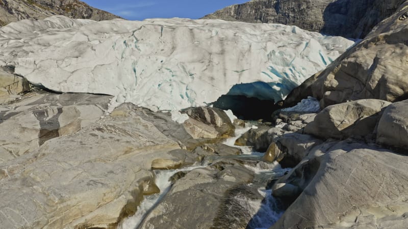 Cascading river over rocks exiting Nigardsbreen Glacier, Norway.