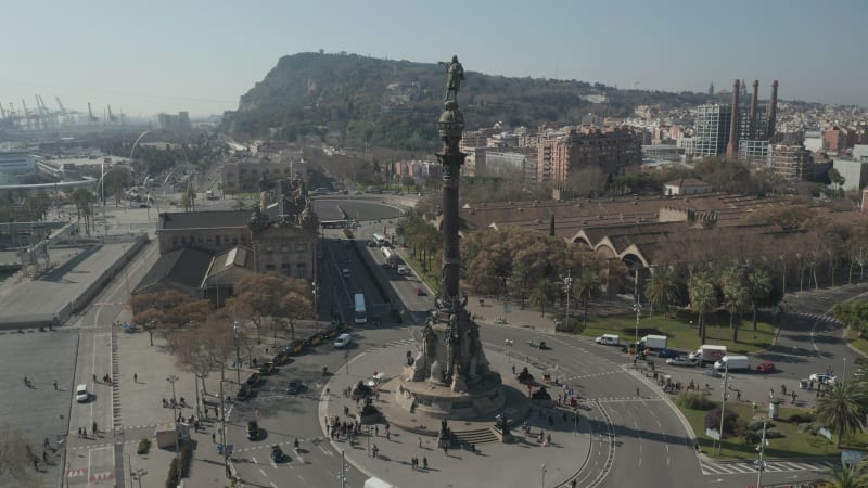 Slow Overhead Flight over Columbus Monument in Barcelona, Spain with Palm Trees on Beautiful Sunny Day