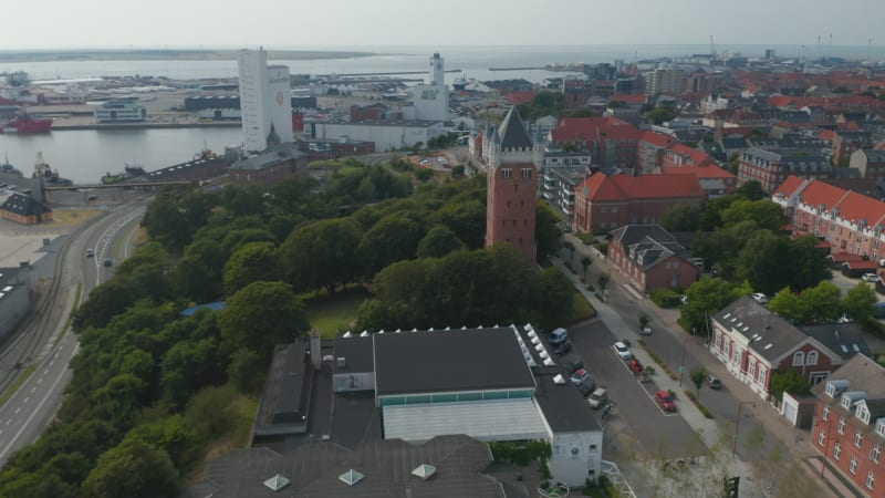 Aerial view slow camera rotation around the Water Tower of Esbjerg, Denmark. Esbjerg Water Tower is an iconic water tower at the top of a cliff overlooking the harbor