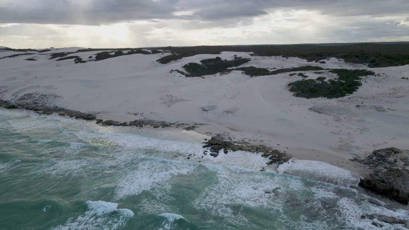 Aerial view of remote beach with man walking, Western Cape, South Africa.