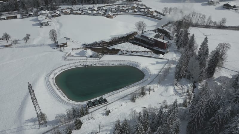 Winter Production at Holzwärme Flachau near a small Lake in Austria