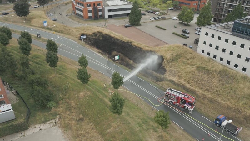 Fire Brigade Extinguishing Roadside Fire in Houten, Netherlands