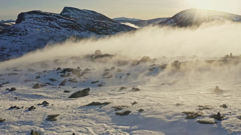 Fog on snow covered mountaintop in Norway.