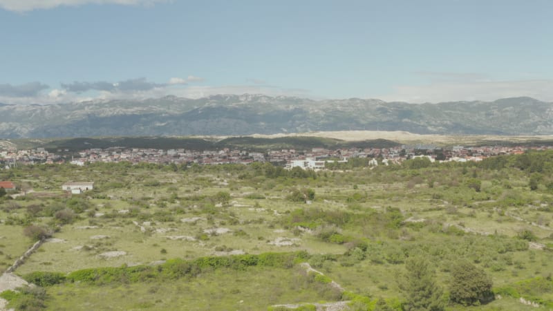 AERIAL: Flight over wilderness, land in Novalja, Croatia Nature with blue sky and sun