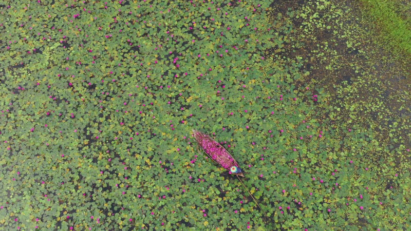 Aerial View of a fisherman working on a small canoe, Dhaka, Bangladesh.