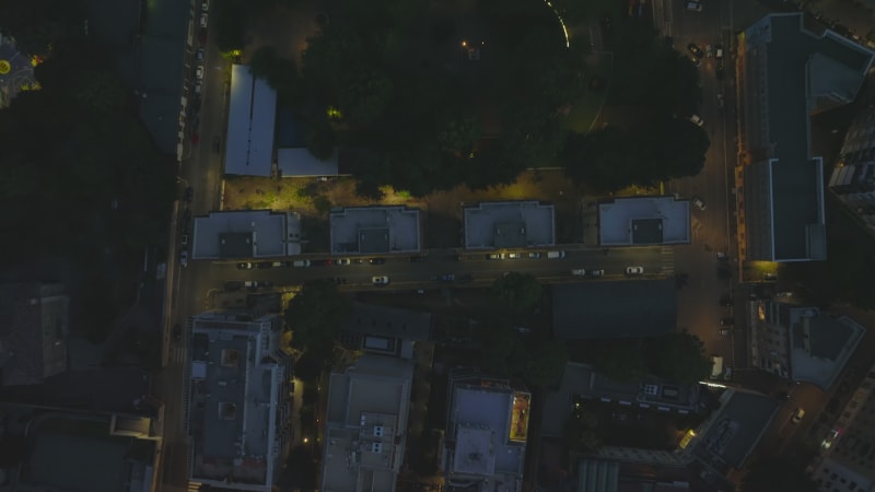 Overhead footage of town development in night city. Apartment buildings and streets lit by lights. Rome, Italy