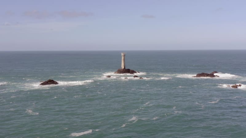 Isolated Lighthouse at Sea on a Rock During the Summer