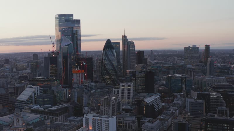 Survolez le quartier moderne de la ville avec ses grands gratte-ciel en soirée. Ciel coloré après le coucher du soleil. Londres, Royaume-Uni