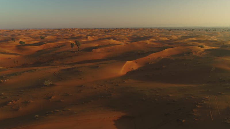 Aerial view of dunes creating shadows at a desert landscape.