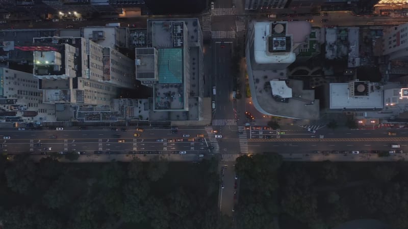 Stunning Top View of City Street at Dusk after Sunset with building rooftops and traffic on intersection in Manhattan, New York City, Aerial Birds Eye Overhead View