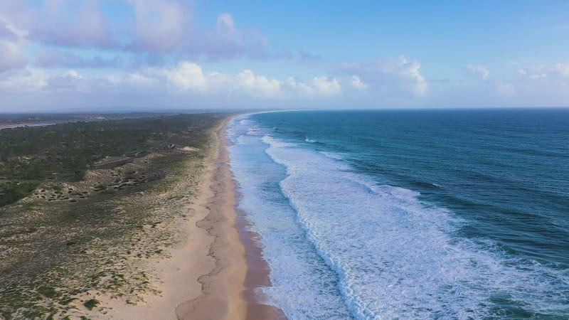 Aerial view of sandy beaches and waves.