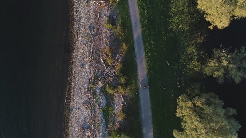 Aerial view of three person cycling a bike along Constance lake, Switzerland.