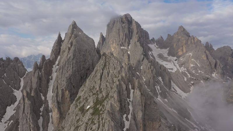 Rotating drone shot of craggy mountains in the Dolomites, natural landscape in the Italian Dolomites