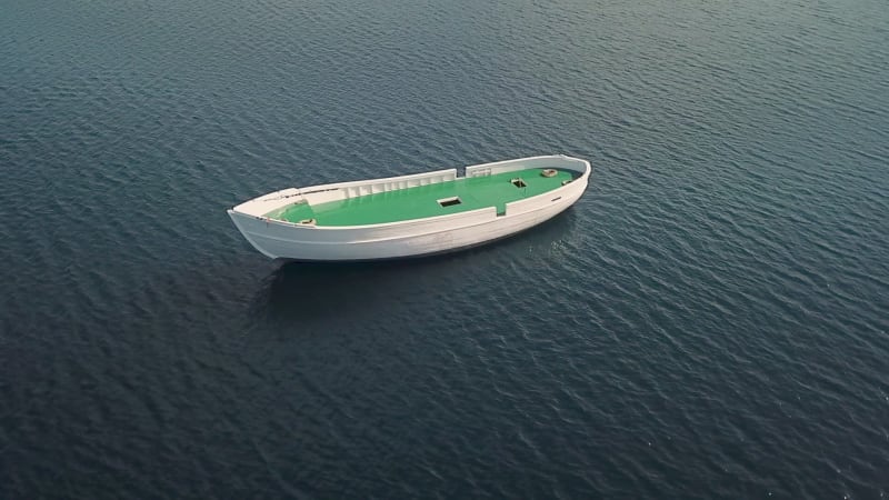 Aerial view of unfinished boat anchored alone at Adriatic sea.