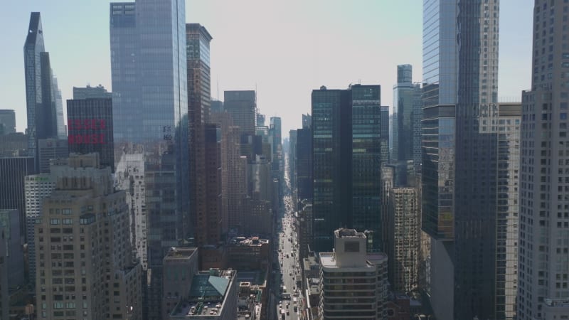 Elevated view of long straight wide street between tall modern downtown skyscrapers. 7th Avenue from north. Manhattan, New York City, USA