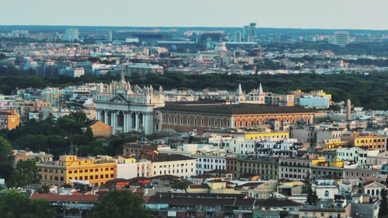 Aerial slide and pan footage of Lateran Palace on Caelian Hill. Zoomed view of ancient palace at twilight. Rome, Italy