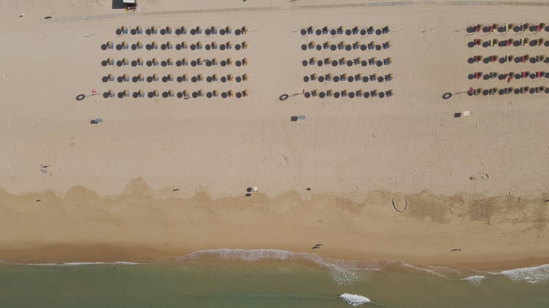 Aerial view of parasols on the beach, Alvor, Algarve, Portugal.