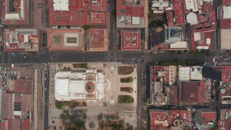 Aerial birds eye overhead top down diagonal panning view of buildings in downtown. Palacio de Bellas Artes and Torre Latinoamericana. Mexico city, Mexico.