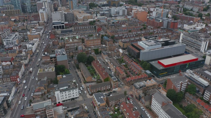 Aerial view of urban district. Tilt down to top down view of street intersection. Rows of townhouses along streets. London, UK