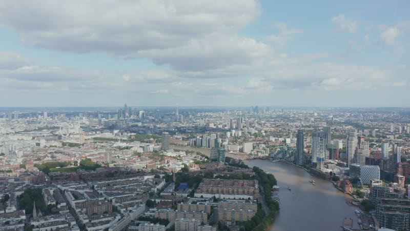 Aerial panoramic view of town. Residential neighbourhoods are interspersed with commercial. Housing estates and tall office buildings. London, UK