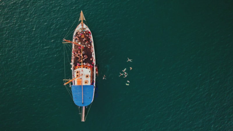 Aerial view of people jumping off the boat in La Valletta, Malta.