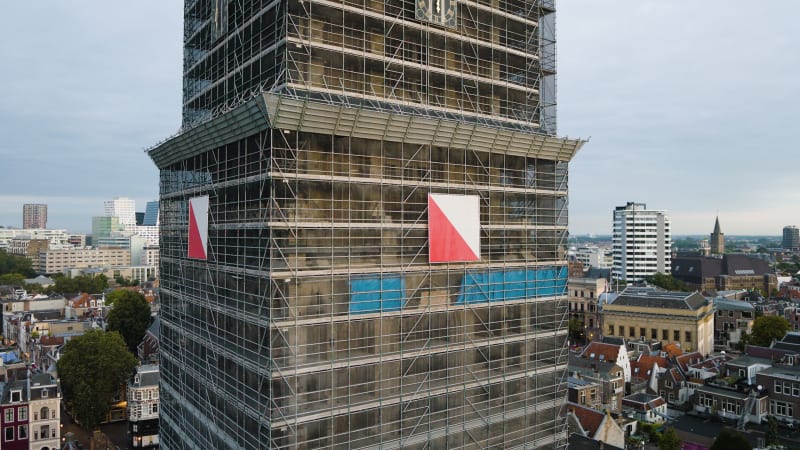 An aerial perspective captures the maintenance and restoration scaffolding the majestic Dom tower in the historic city of Utrecht.