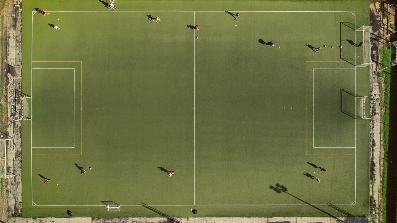 Aerial view of a football training in a football pitch on a summer day.