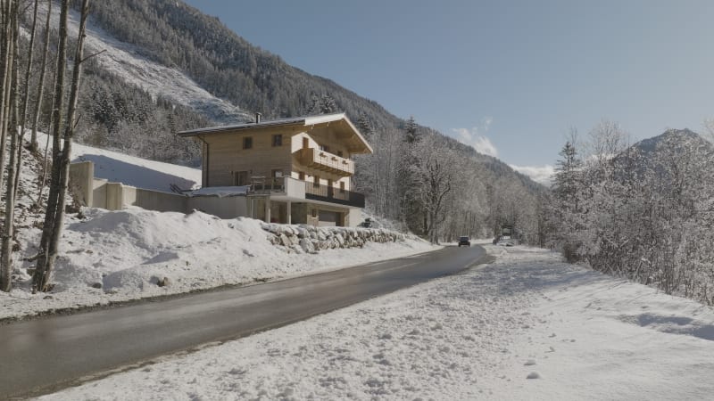 Car Driving on Snowy Mountain Road in Flachau, Austria