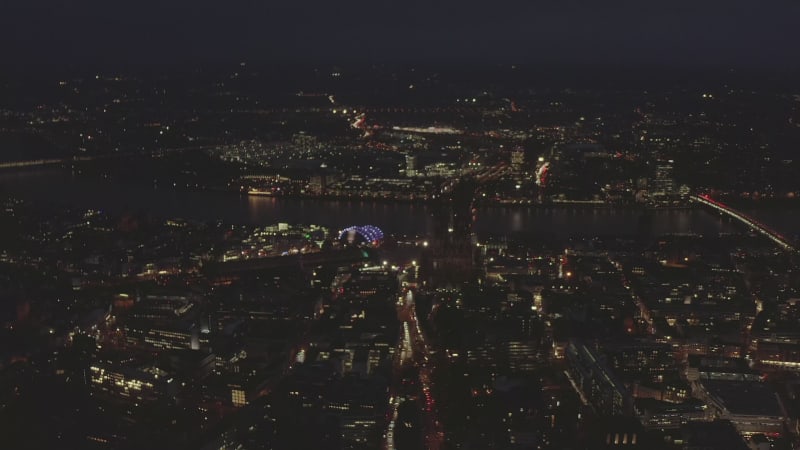 AERIAL: Slow Overhead Shot of City at Night with Lights and Traffic, Cologne, Germany