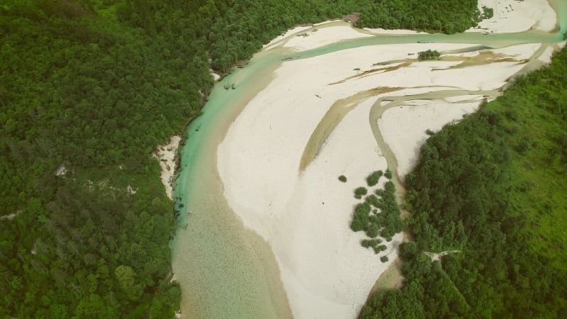 Aerial view of a group of people doing white water rafting on rapids.