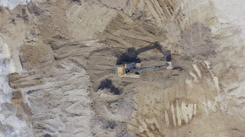 Groundworks Digger Moving Earth During Construction