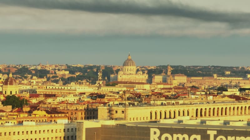 Monumental St. Peters Basilica in Vatican City with large dome. Zoomed view above buildings in city centre. Rome, Italy