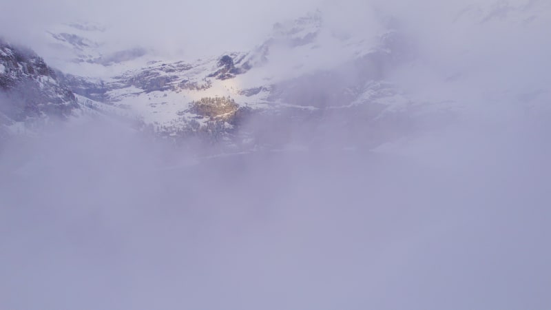 Oeschinen Lake in the Snowy Mountains of Switzerland on a Foggy Morning