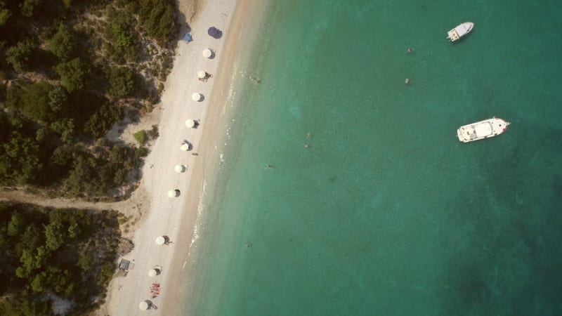 Aerial view of a paradise beach with turquoise water and white sand in Syros