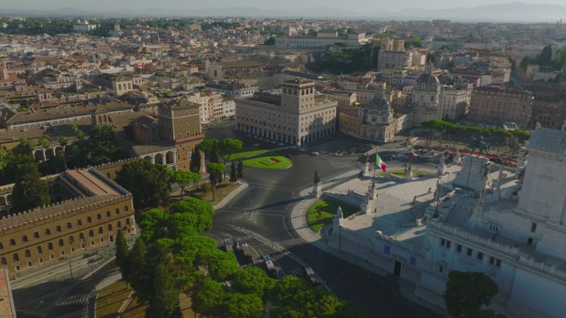 Amazing aerial slide and pan footage of Piazza Venezia square surrounded by historic buildings. Revealing of majestic Vittoriano monument with statues of goddess Victoria. Rome, Italy