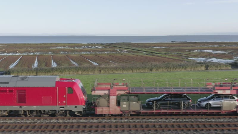 Moto Rail Train Carrying Vehicles and Passengers on a Journey