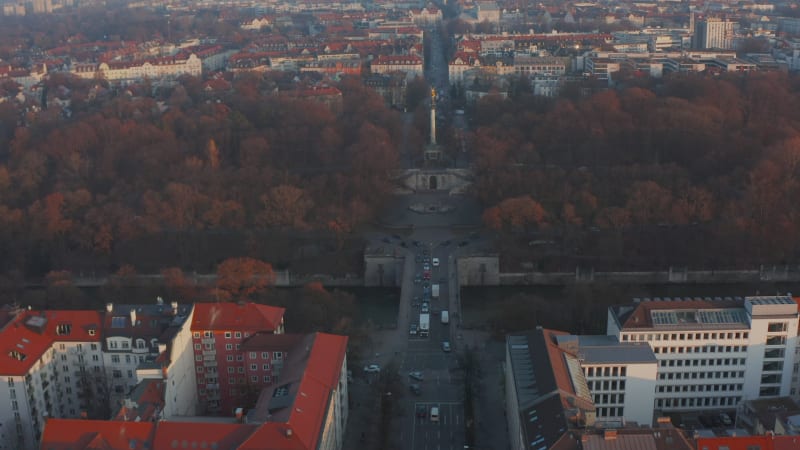 Slow tilt up revealing Angel of Peace Statue Monument in Munich, Germany in Winter with Car traffic, Aerial Dolly in forward