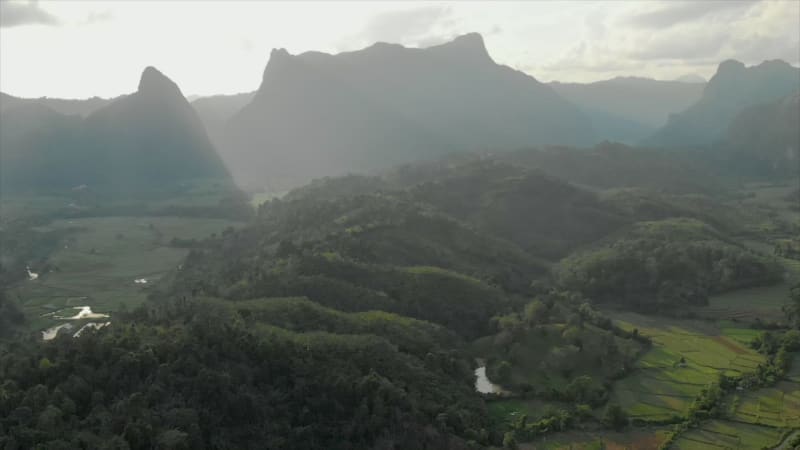 Aerial view of forests, hills, and rice fields