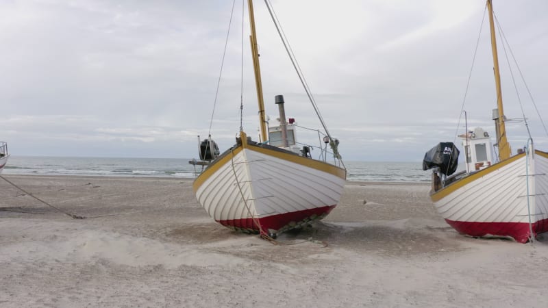 Old Fishing Boats Lined Up Ashore on Thorup Strand Beach in Denmark