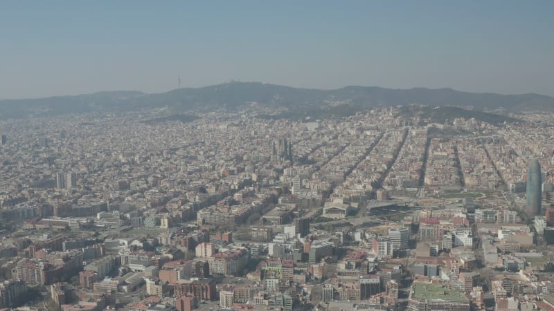 Barcelona Wide Drone Shot of City Towards Center with La Sagrada Familia and Torre Glories, Torre Agbar