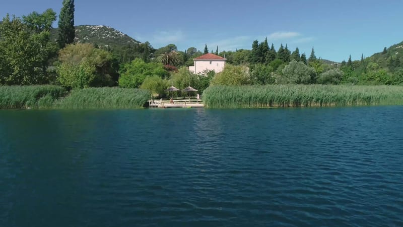 Aerial view of kitesurfing spot on the Neretva delta valley river.