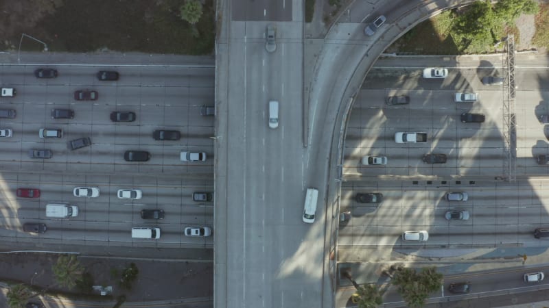 Freeway Highway intersection in Sunny California next to Downtown Los Angeles Skyline with a lot of car traffic, Aerial Birds Eye Overhead Top Down View from above