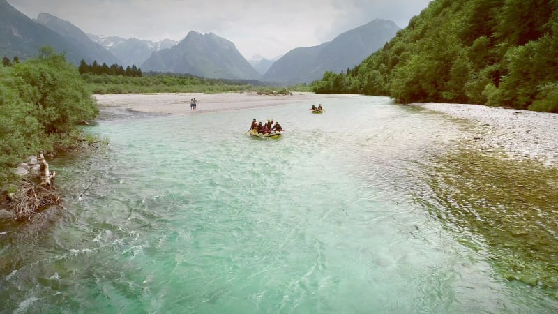 Aerial view of rafters doing rafting with clear water.