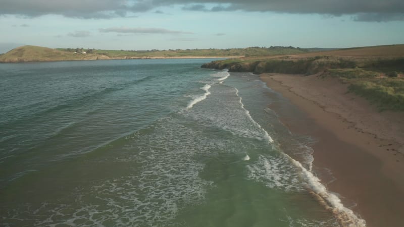 Aerial view of waves breaking on the beach in Cornwall, United Kingdom.