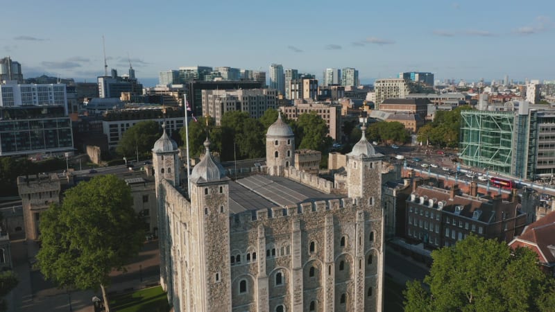 Aerial view of medieval keep White Tower. Historic landmark Tower of London in bright afternoon sun. London, UK