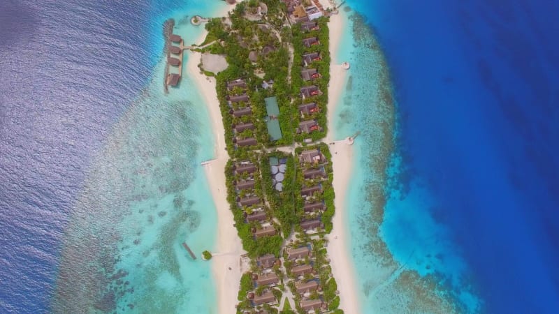 Aerial view of bungalow resort in the middle of forest.