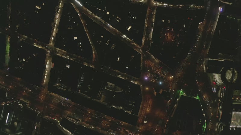 AERIAL: Beautiful Overhead Shot of busy intersection at night with Car traffic and city lights