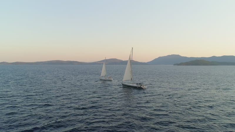 Aerial view of two sailboat anchored in the mediterranean sea, Vathi.