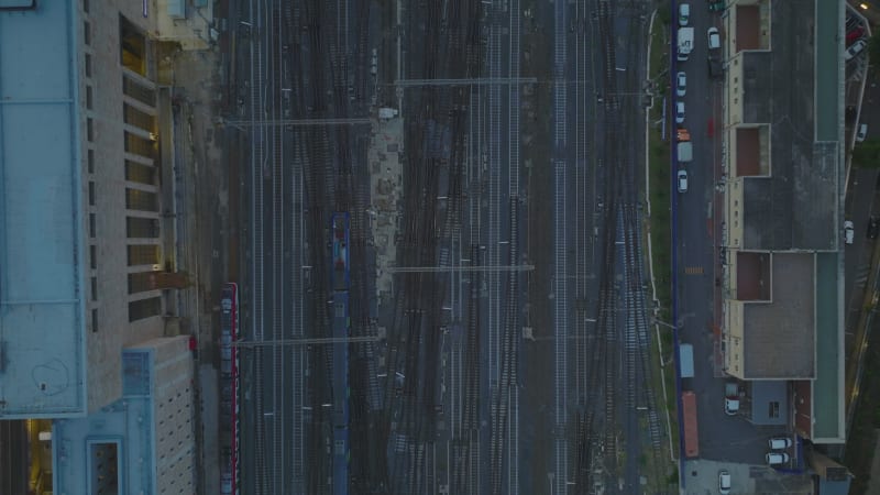 Top down panning footage of train passing through turnouts on railway track. Approaching central train station. Rome, Italy