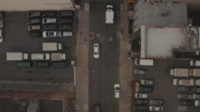 Overhead Top Down Birds View following an ambulance going under a bridge